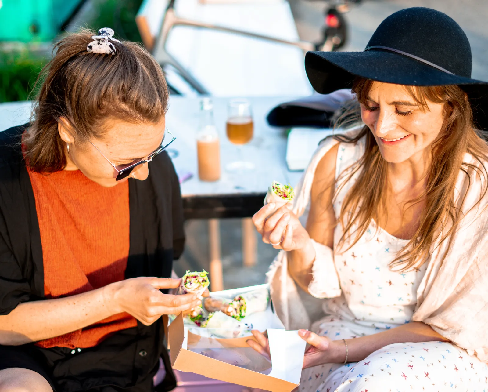 To gæster spiser street food fra en foodtruck udendørs
